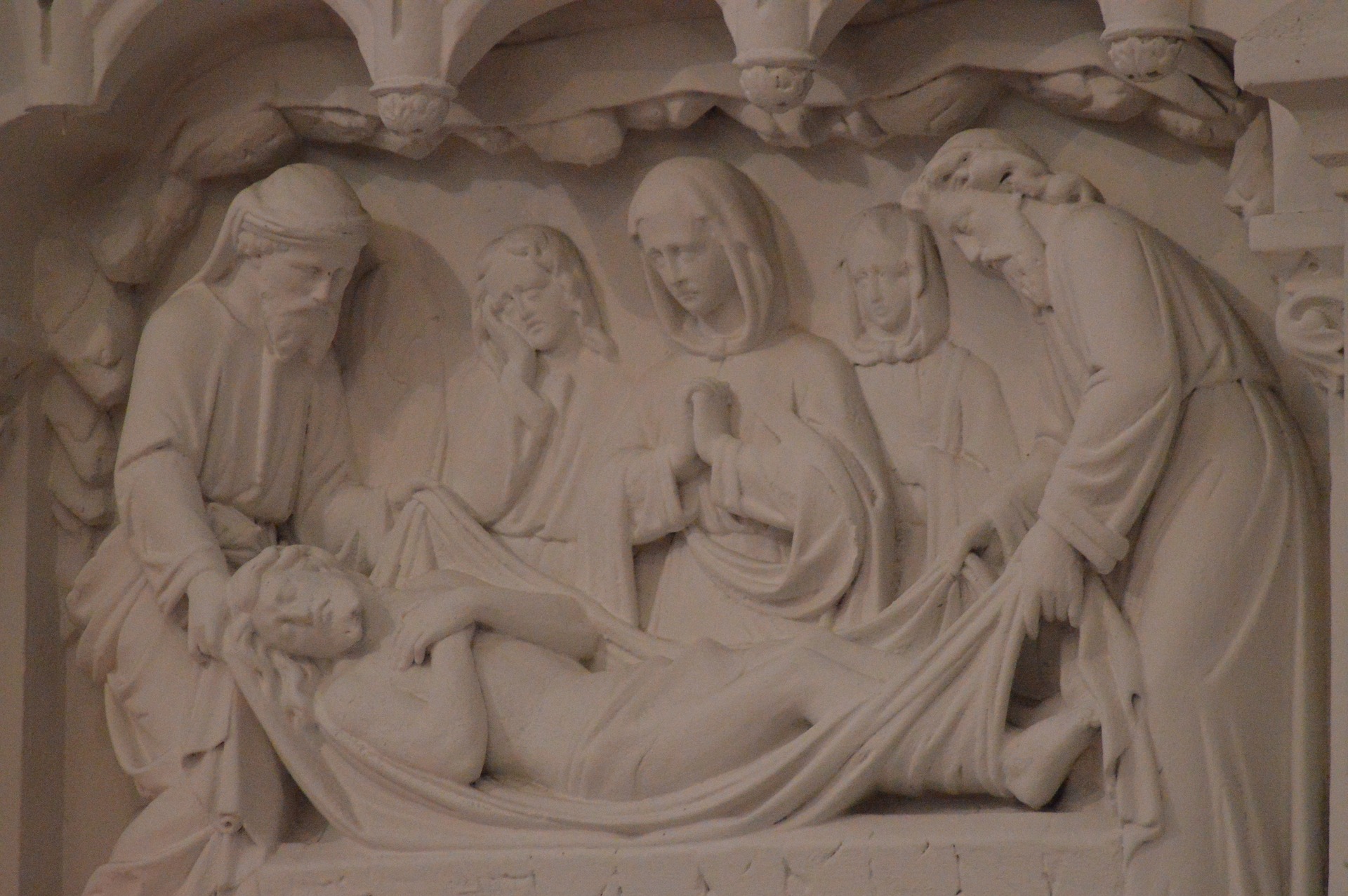Women, along with Joseph and Nicodemus, standing beside Jesus at the tomb.